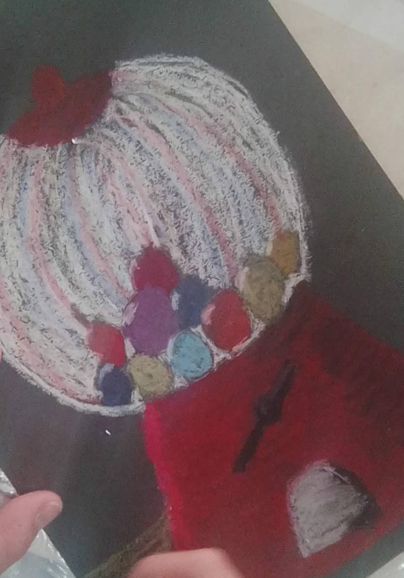 An oil-pastel gumball machine on black paper