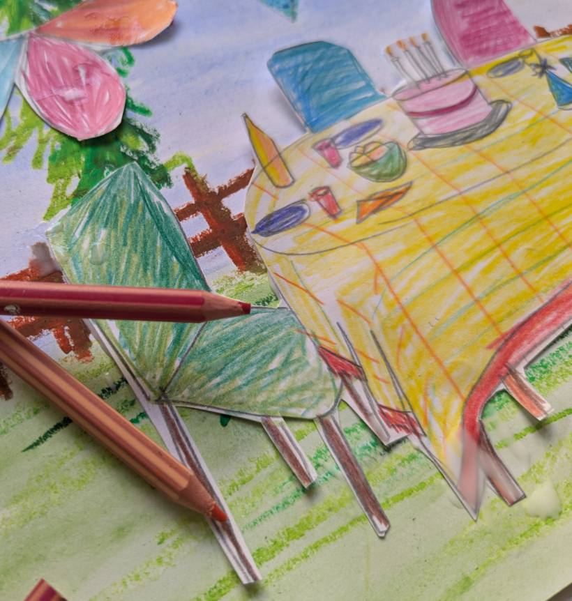 A cut-paper collage of a garden picnic table and butterfly