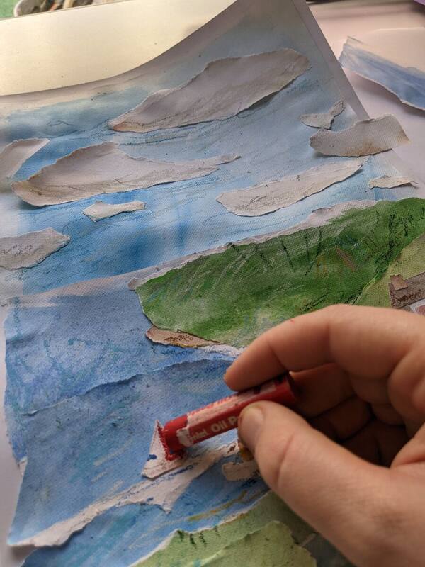 A torn-paper sea collage in progress