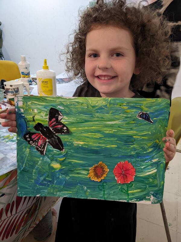 An Artitup student with a colourful butterfly painting